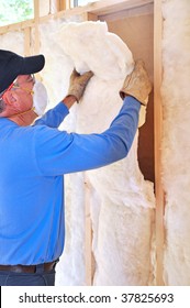 Man Installing Fiberglass Insulation