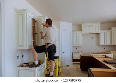 Man Installing Kitchen Cabinets Door