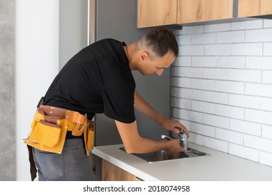 Man Installing The Kitchen Tap And The Sink