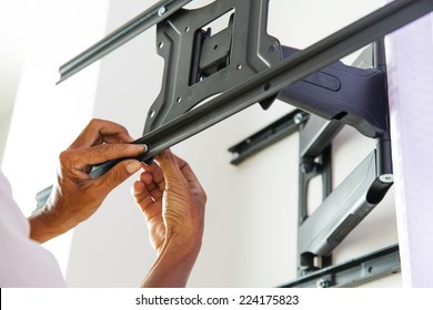 Man Installing Mount TV On The Wall At Home