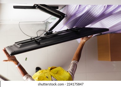 Man Installing Mount TV On The Wall At Home