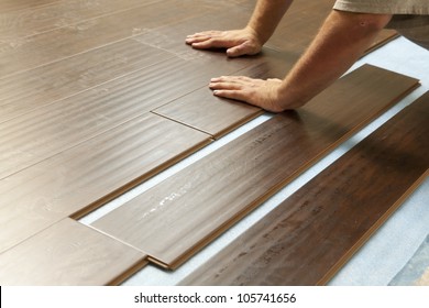 Man Installing New Laminate Wood Flooring Abstract. - Shutterstock ID 105741656