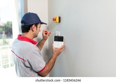 Man Installing Security Alarm System