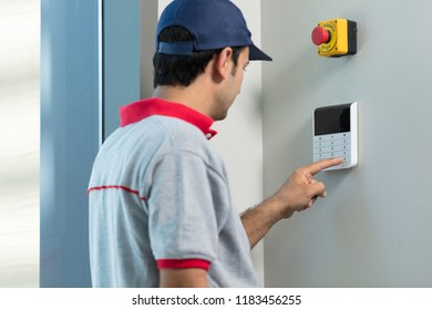 Man Installing Security Alarm System