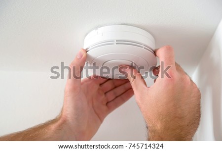 Man installing smoke or carbon monoxide detector Stock photo © 