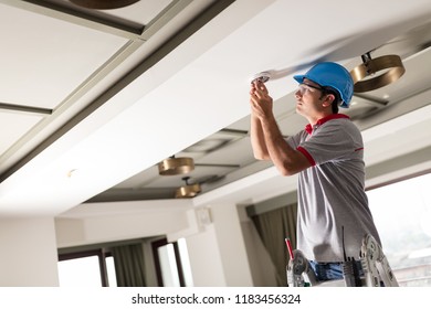 Man Installing Smoke Detector