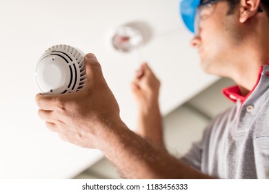 Man Installing Smoke Detector