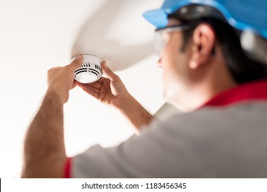 Man Installing Smoke Detector