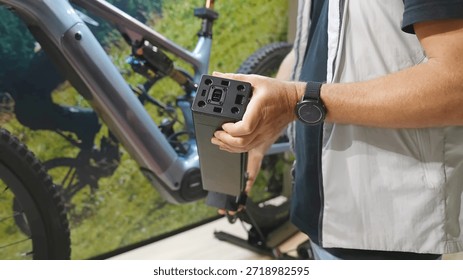 Man installing a Specialized e-bike internal battery in a bicycle frame lightweight electric bike