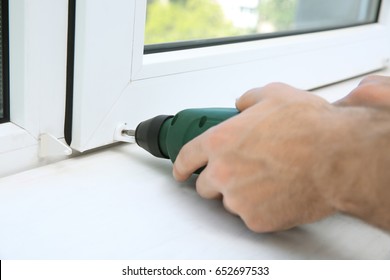 Man Installing Window Shades At Home