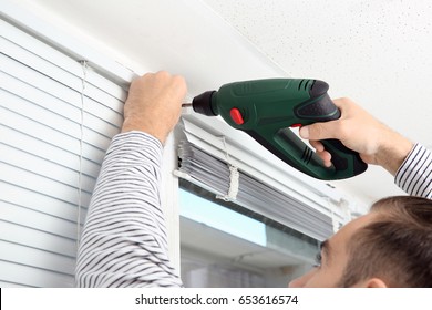 Man Installing Window Shades At Home