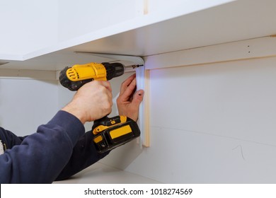 Man Installing Wooden Shelves On Brackets Wall Installing A Shelf