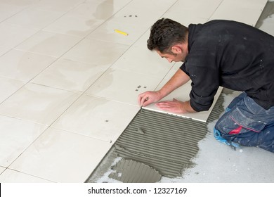 Man Installs Ceramic Tile