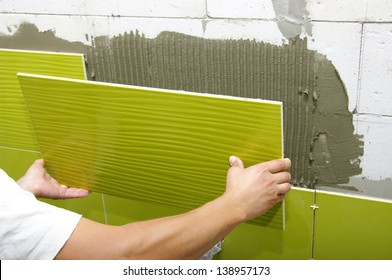 Man Installs Ceramic Tile