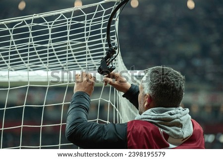 Man installs a TV camera in a football goal
