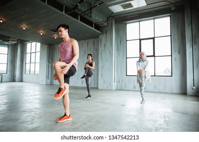 Man Instructure Leading Stretching Before Entering Core Exercise At The Gym