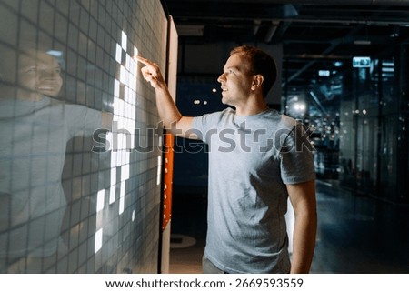Man Interacting with Digital Touchscreen Wall