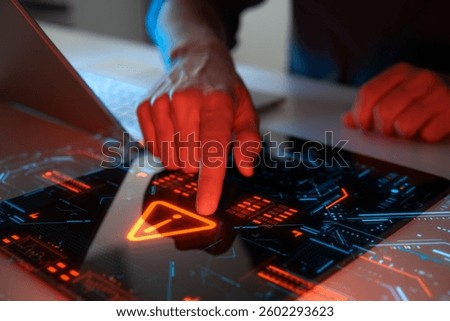Man interacting with a holographic touchscreen interface in red color. Concept of cyber attack, malware, data breach, system hacking, virus, spyware, compromised information and urgent attention.