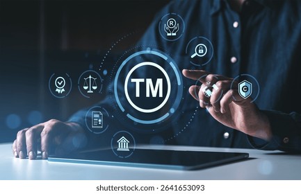 Man interacting with trademark protection icons on a digital interface, futuristic style, dark background, concept of legal intellectual property