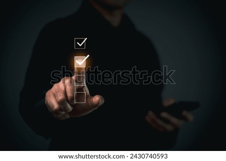 Man Interacting with Virtual Checklist Interface. Corporate executive interacting with a glowing virtual checklist, futuristic technology concept.