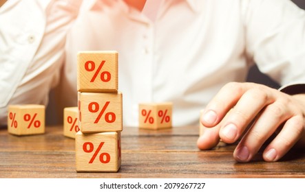 Man and interest rates. Interest rate on loan or deposit. Profit investments, dividends and yield on securities assets. Debt burden, high indebtedness. Financial literacy. Credit score calculation - Shutterstock ID 2079267727