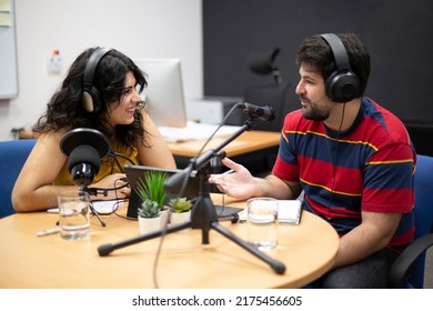 Man Interviewing Female Guest During The Live Recording Of A Podcast Or Radio Show. Concept Of Online Communication And Content Creation.