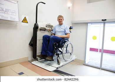 man in an invalid chair walks upstairs on the special elevating device