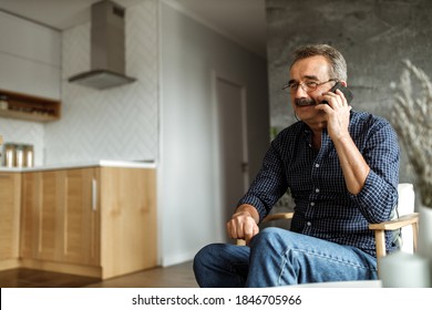 Man inviting his friends for dinner, making phone call.