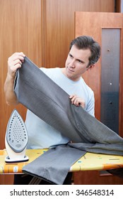 Man Ironing His Pants. Housework