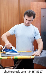 Man Ironing His Pants. Housework