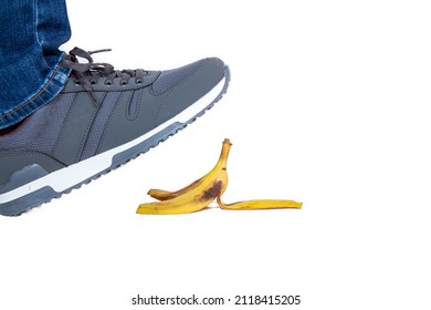 Man isolated on white background about to step on a banana peel. Funny jokes concept. Banana peel put on the floor for a joke.