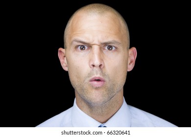 Man Isolated Over A Black Background With A Humorous, Confused Look On His Face.