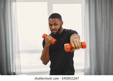 Man in a isolations. Guy training in a room. Man with dumbbells. - Powered by Shutterstock