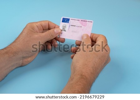 a man with an Italian driving license in the hands