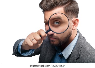 Man In A Jacket With Magnifying Glass Isolated On White Background