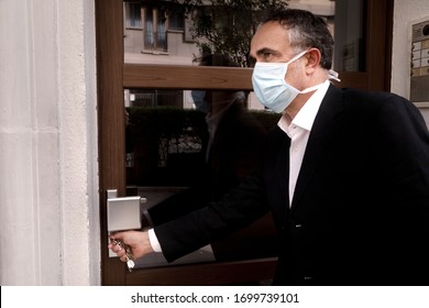 Man In Jacket With Protective Face Mask, Is Leaving His House Worriedly Because Of The Coronavirus