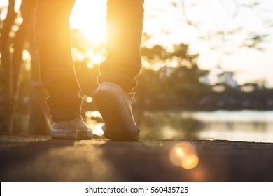 Man Jeans And Sneaker Shoes Walking On The Road Sunset Light