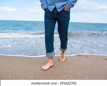 Man In Jeans Walking Along The Coast