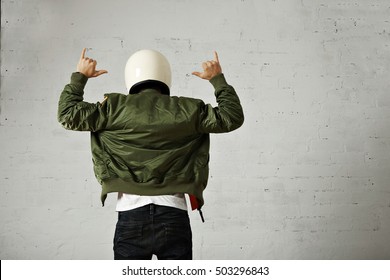 Man In Jeans, White T-shirt, White Motorcycle Helmet And Bomber Jacket Gesturing With His Hands, Back Shot