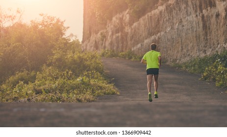 Man Jogging On A Downhill / Uphill In Suburb Mountain Road.