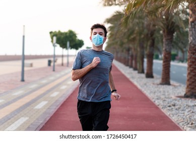 Man Jogging On The Running Track Wearing Protective Surgical Mask