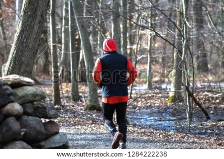 Similar – Young man running outdoors during workout in a forest