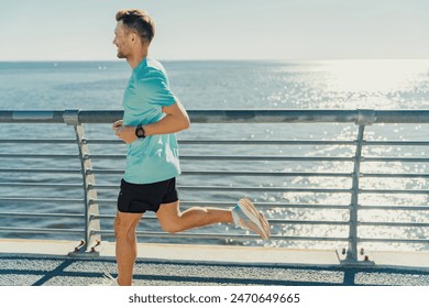 A man jogs along a sunny seaside path, enjoying the fresh air and picturesque ocean view.

 - Powered by Shutterstock