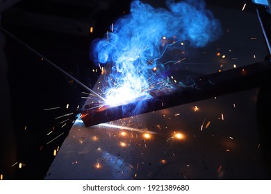 Man Joining Iron Profiles By Welding