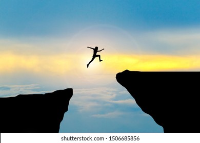 Man Jump Through The Gap Between Hill.man Jumping Over Cliff