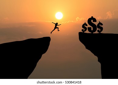 Man Jump Through The Gap Between Hill To Get Money. Business Concept Idea