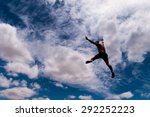 Man jumping with a cloud background 