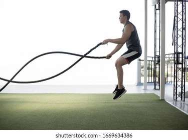 Man Jumping With Cross Fit Rope Whit Foreground White