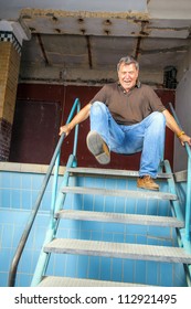 Man Jumping Down The Stairs Of An Old Waterless Pool