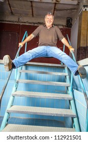 Man Jumping Down The Stairs Of An Old Waterless Pool